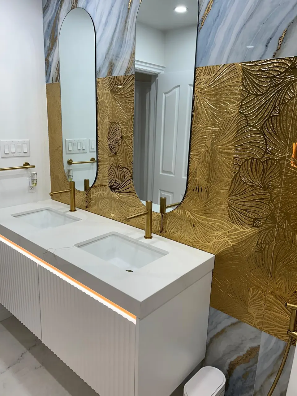 Double fluted vanity with gold feature wall and arched mirrors