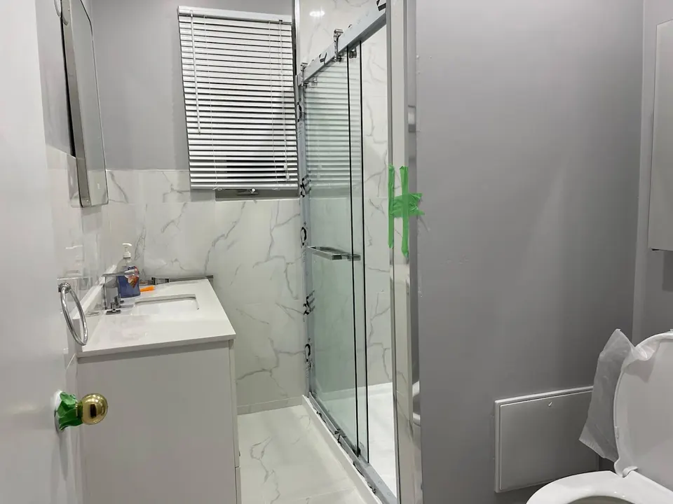 Small bathroom with sliding glass shower door