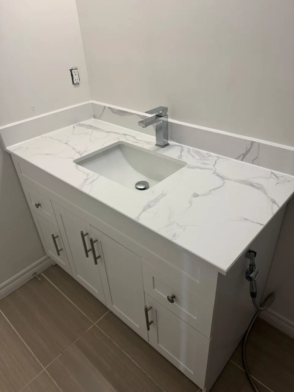 White shaker vanity with quartz countertop